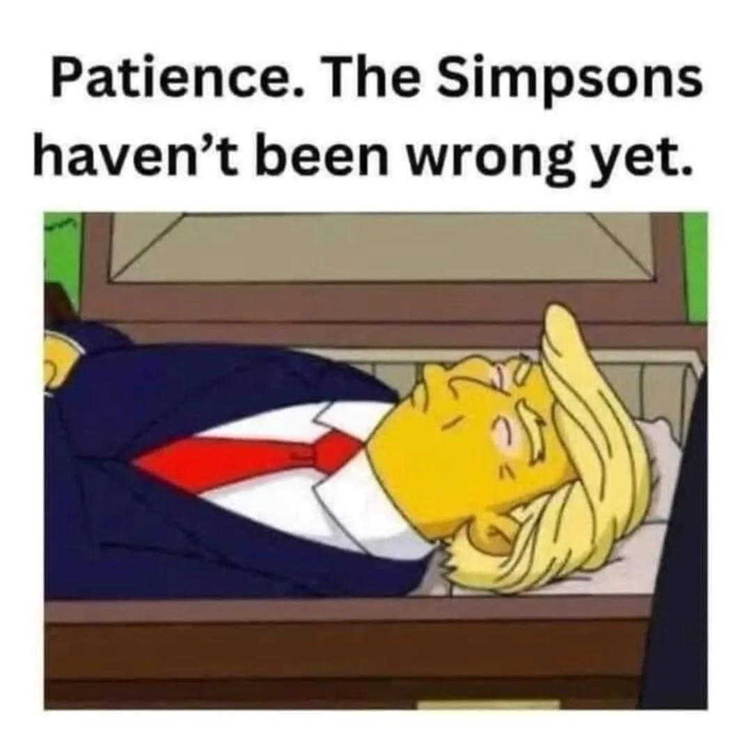 A cartoon image shows a yellow-skinned man with long blonde hair, wearing a dark suit and red tie, lying on his back on a…