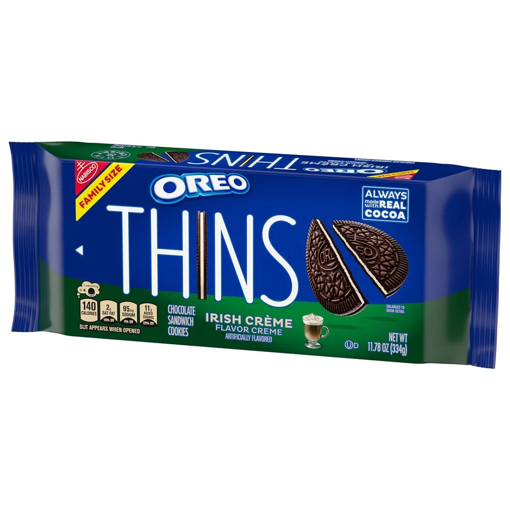A product shot of a blue and green Oreo Thins family-size package featuring Irish Crème flavor. The packaging displays…