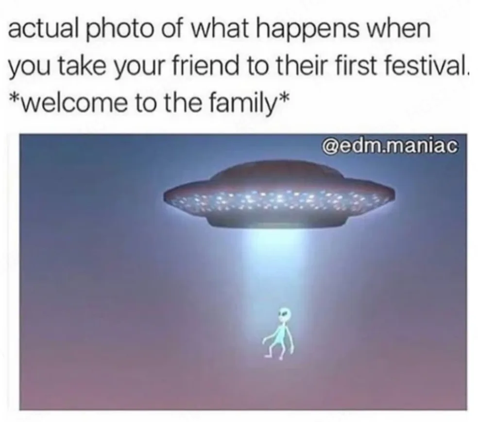 The image shows a classic cartoon-style UFO hovering in a gradient purple sky, emitting a bright beam of light that…