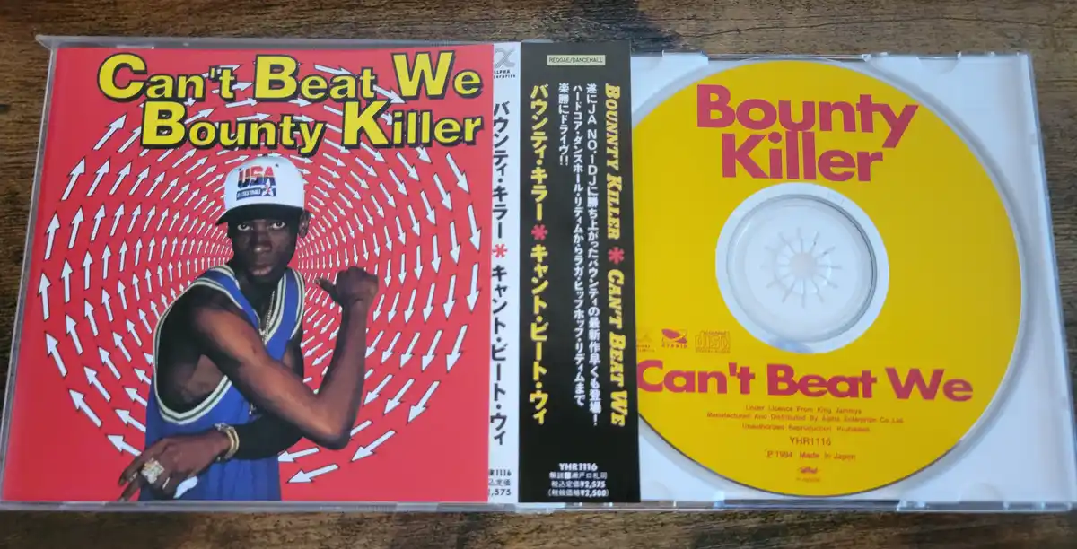 A Japanese CD release of Bounty Killer's album 'Can't Beat We' shows the artist on the cover pointing at the viewer against…