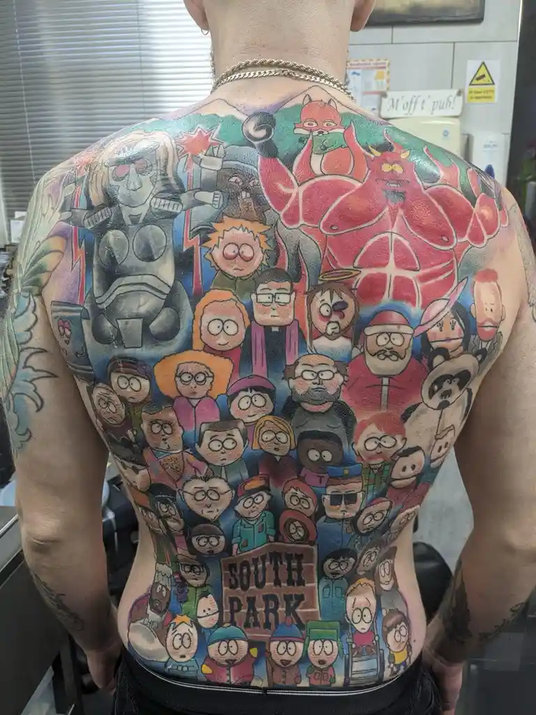 A person's entire back is covered in a large, colorful tattoo featuring dozens of characters from the animated TV show South…
