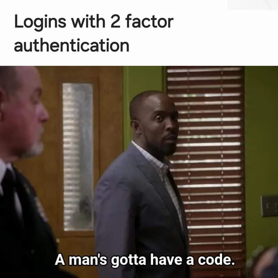 A still from a TV show shows a Black man in a suit looking over his shoulder with a serious, slightly amused expression. The…