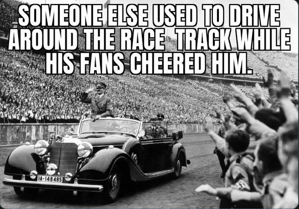 A black-and-white historical photograph shows a man in a military uniform saluting from the driver's seat of a vintage…