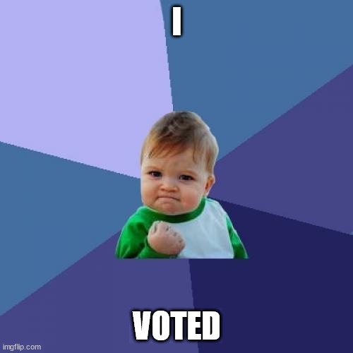 A baby with a determined, slightly smug expression, wearing a green and white shirt, clenches a fist. The image has a…