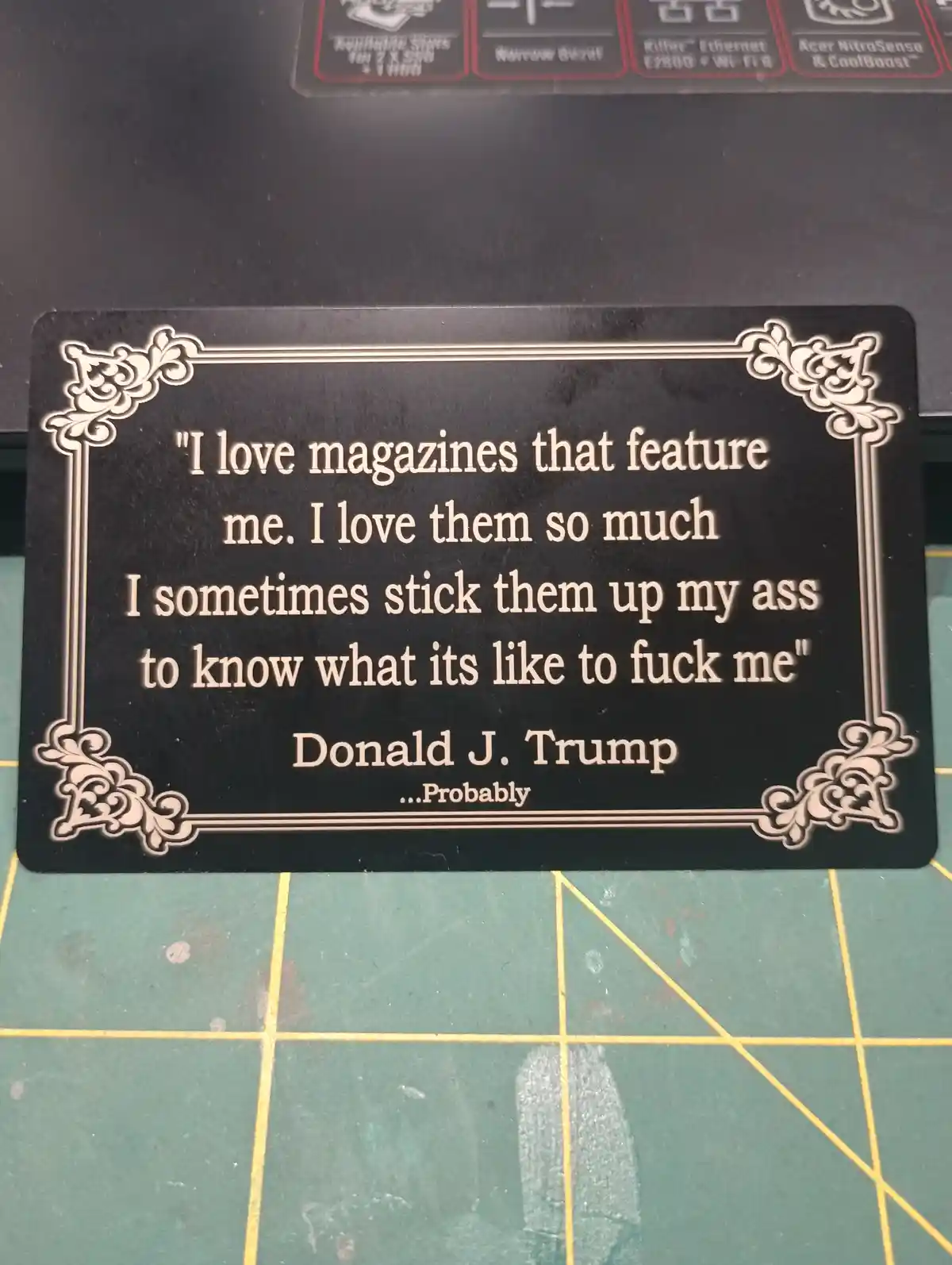 A black plaque with ornate white borders displays a satirical quote attributed to Donald J. Trump, which reads: "I love…