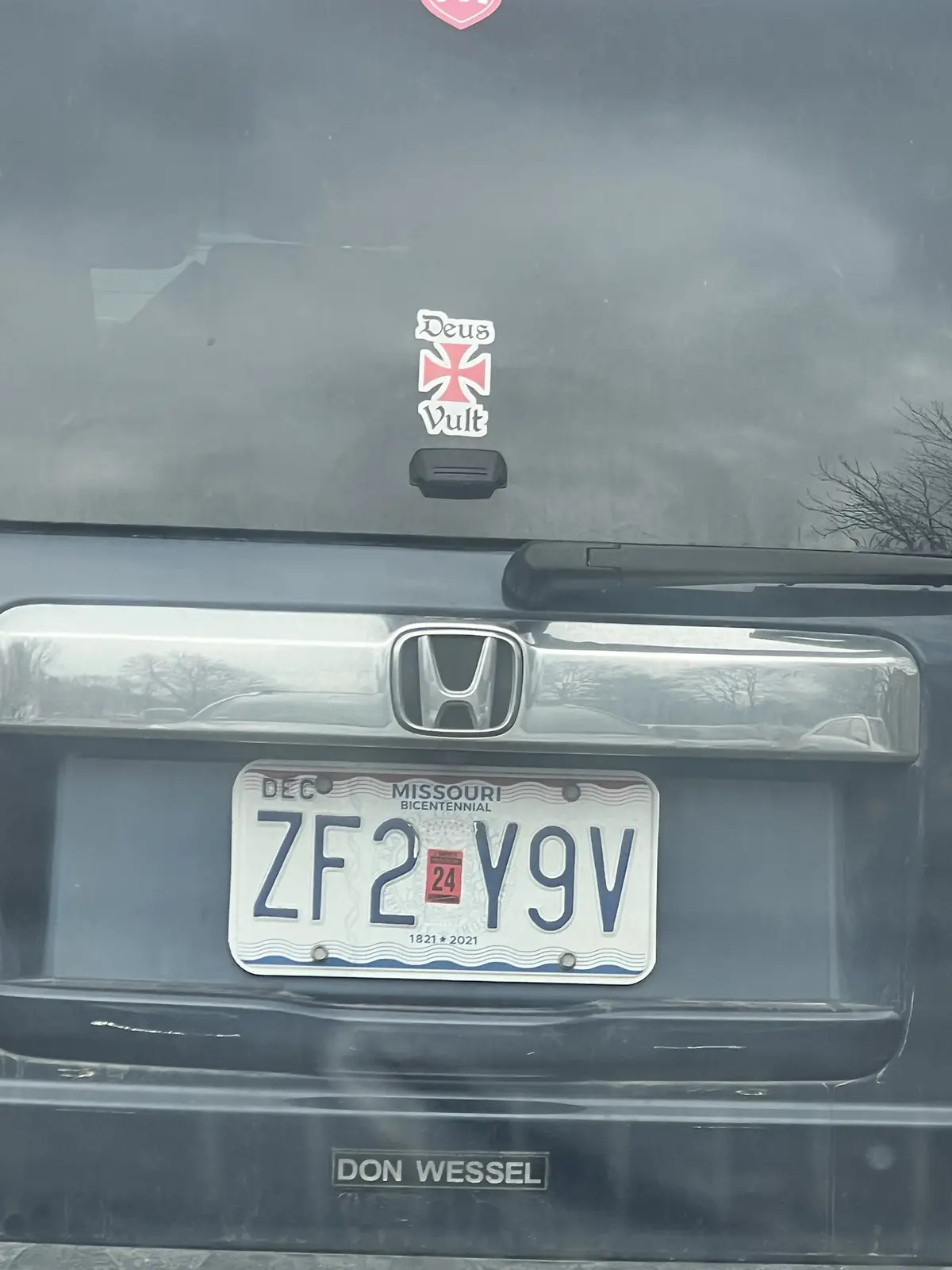 The image shows the rear of a dark gray Honda vehicle with a Missouri bicentennial license plate reading ZF2 Y9V. Above the…