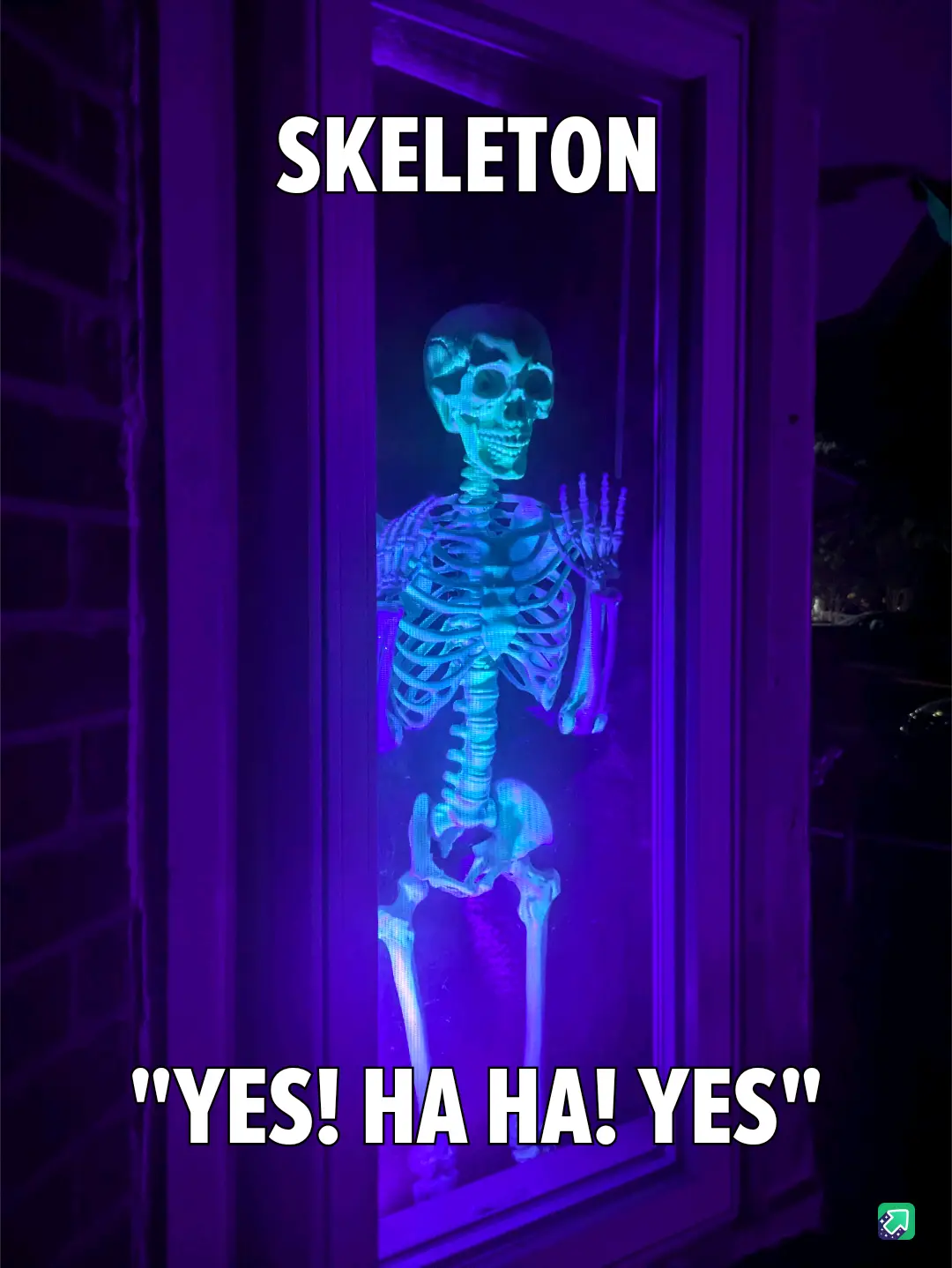 A glowing blue skeleton decoration stands inside a window framed by dark wood, illuminated by purple light against a brick…