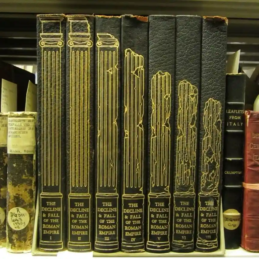 A row of seven black leather-bound books titled 'The Decline & Fall of the Roman Empire' volumes I through VII, each with…