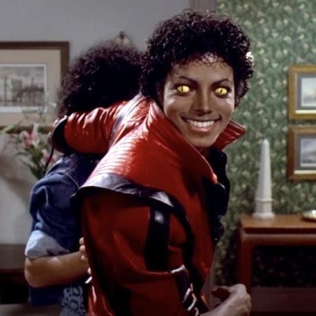 A still from Michael Jackson's 'Thriller' music video shows him in a red jacket with glowing yellow eyes, smiling while…