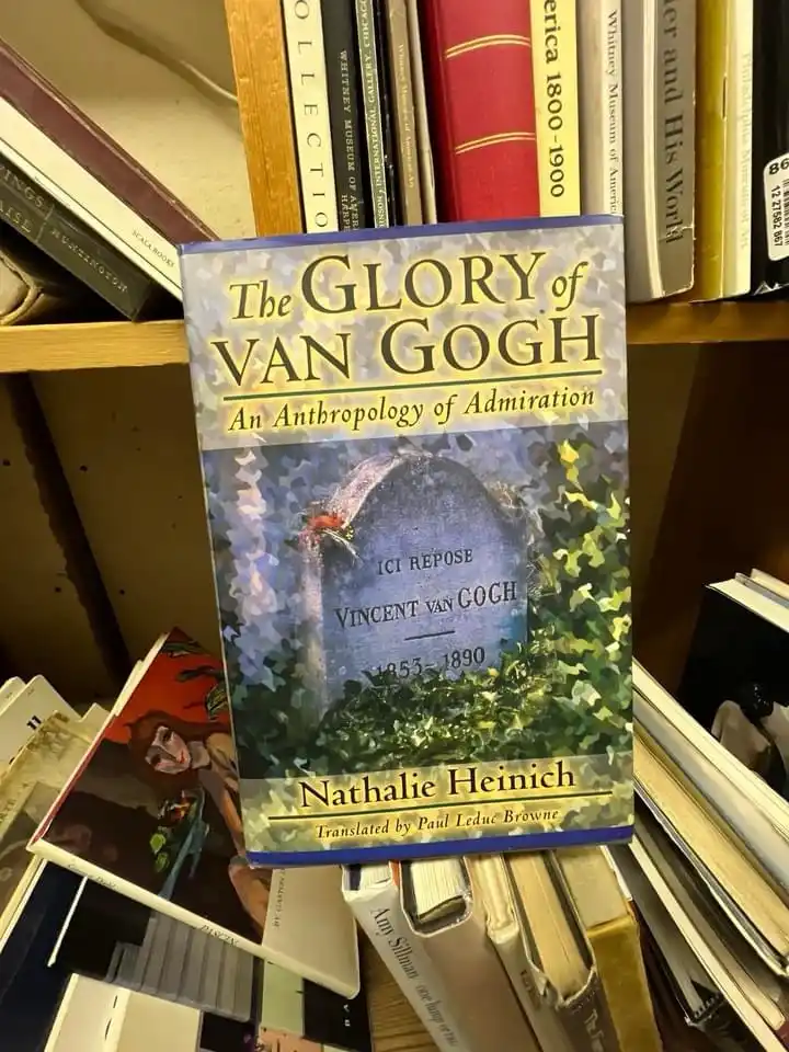 A book titled 'The GLORY of VAN GOGH: An Anthropology of Admiration' by Nathalie Heinich is shown on a bookshelf. The cover…