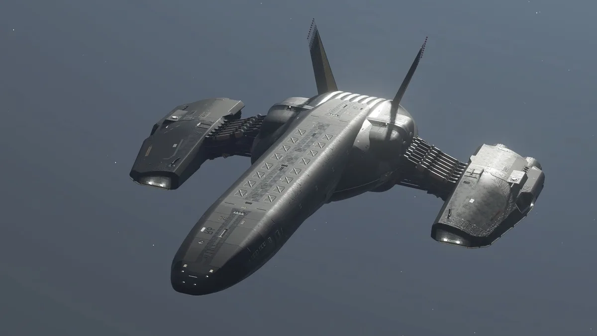 A detailed, grey spaceship with angular wings and twin vertical fins is shown floating in space against a starry background…