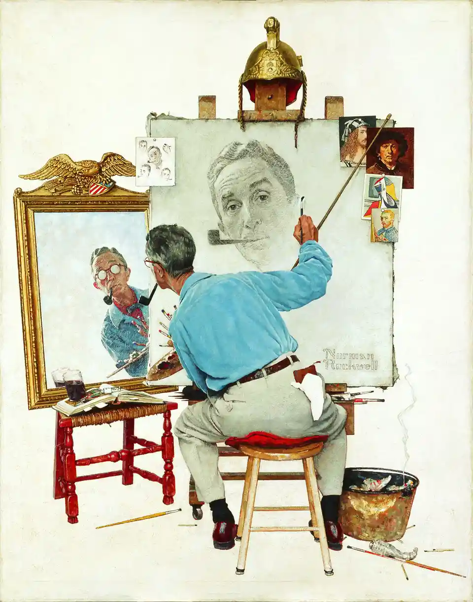 An artist in a blue shirt and grey pants sits on a wooden stool, painting a large portrait of himself on an easel. He holds…