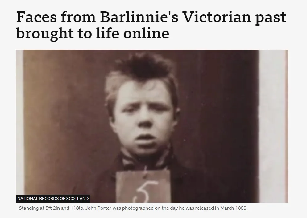 A sepia-toned historical mugshot of a young man with a surprised expression, holding a card with the number 5. The image is…