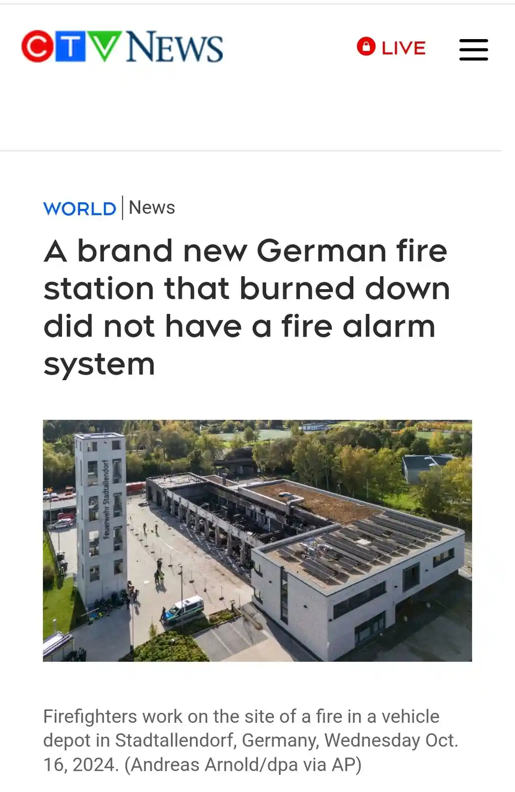 An aerial photo shows a modern German fire station severely damaged by fire, with charred remains and intact adjacent…