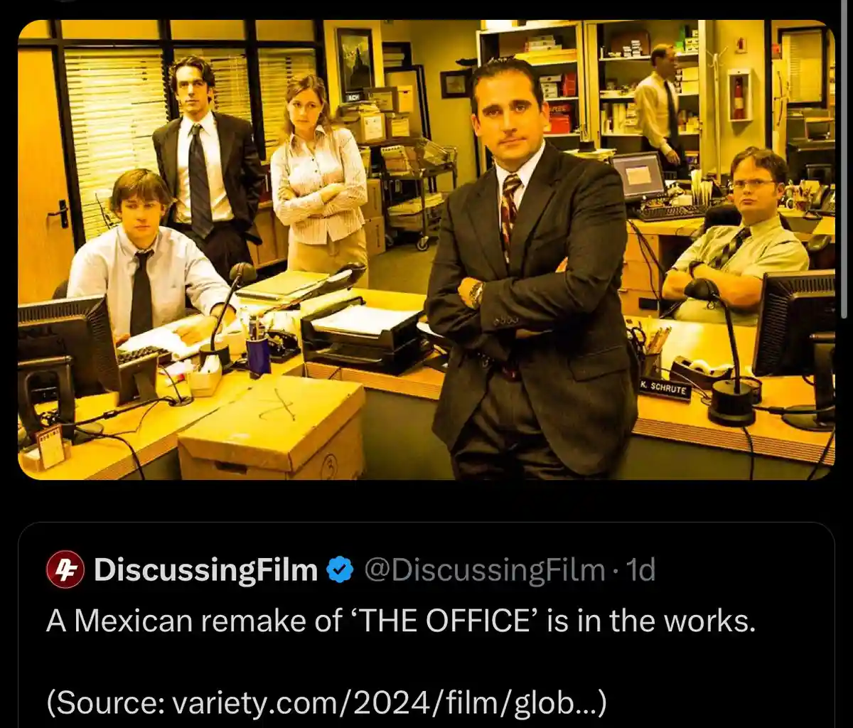 The image shows the main cast of the TV show 'The Office' standing in their office, with Michael Scott in the center looking…