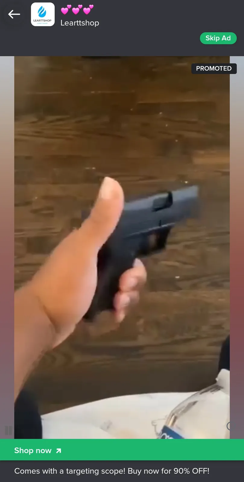 A blurry video frame shows a hand holding a black handgun against a wooden floor background, overlaid with promotional text…