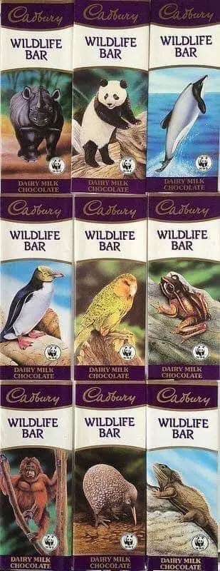 A grid of nine Cadbury Wildlife Bar chocolate wrappers, each featuring a different animal: a rhino, panda, dolphin, penguin…