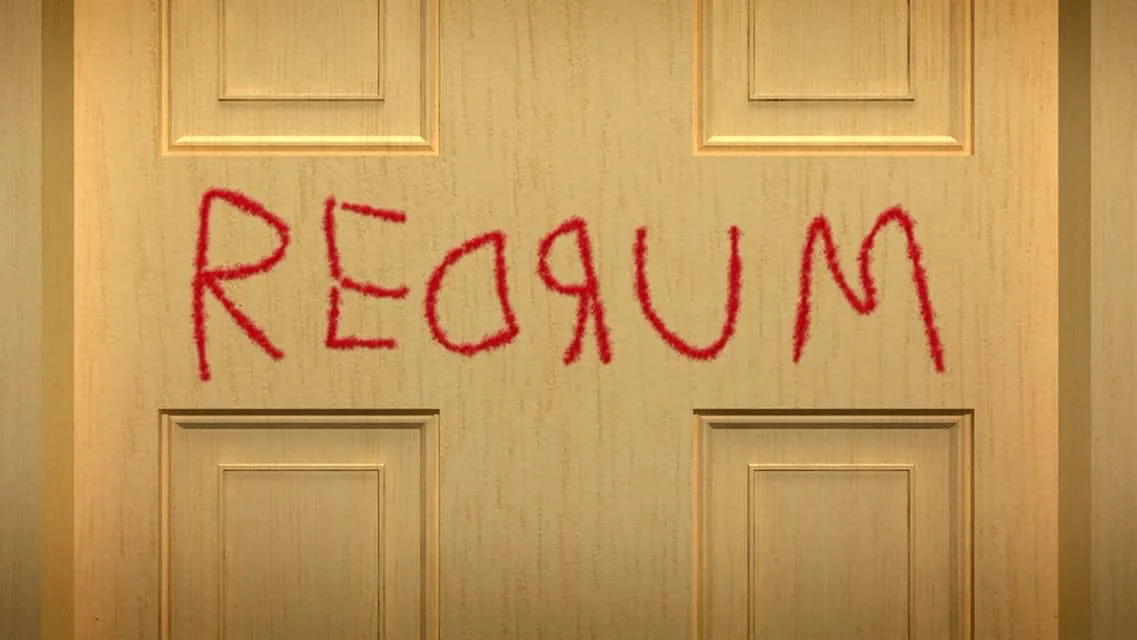 A close-up of a light-colored wooden door with four recessed panels, featuring the word 'MURDER' written in red, jagged…