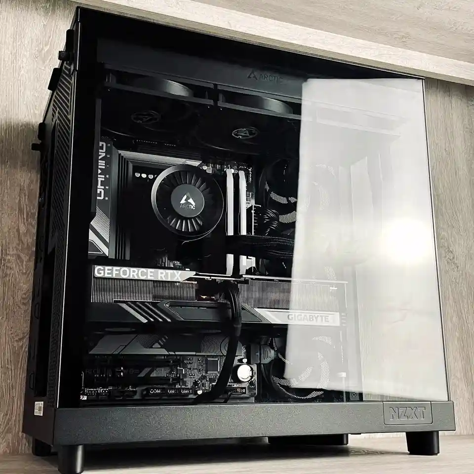 A black NZXT computer case with a clear side panel, revealing internal components including a Gigabyte GeForce RTX graphics…