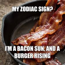 A close-up photo of crispy, cooked bacon strips resting in a black cast-iron skillet. Overlaid white text reads: 'MY ZODIAC…