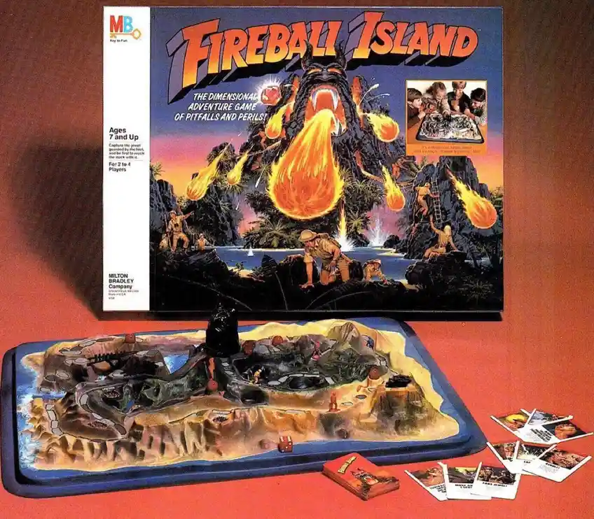 A vintage Milton Bradley board game called 'Fireball Island' is shown with its box and 3D game board. The box art depicts a…