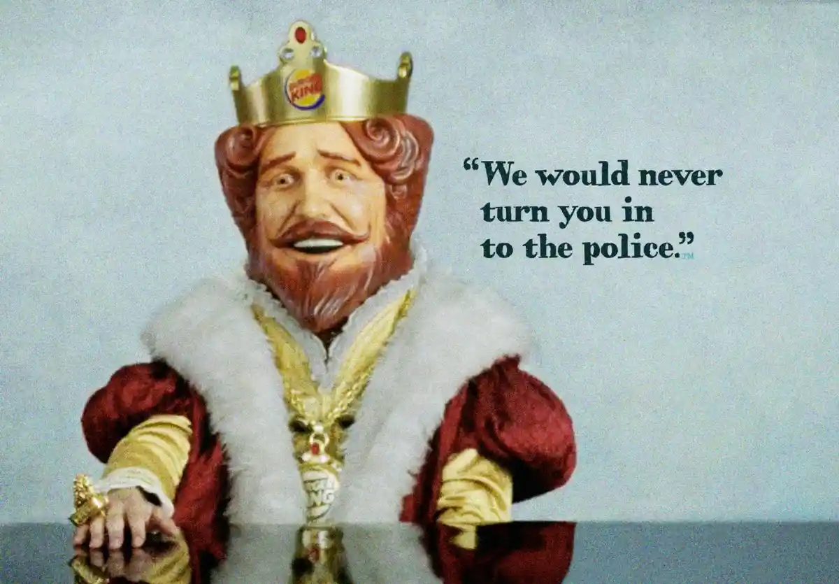A statue of the Burger King mascot, dressed in royal attire with a crown and fur-trimmed robe, is shown with overlaid text…