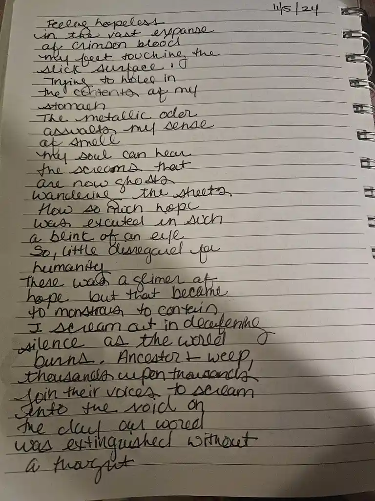 A close-up photo of handwritten poetry in a spiral-bound notebook, dated 11/5/24, describing a deeply emotional and…
