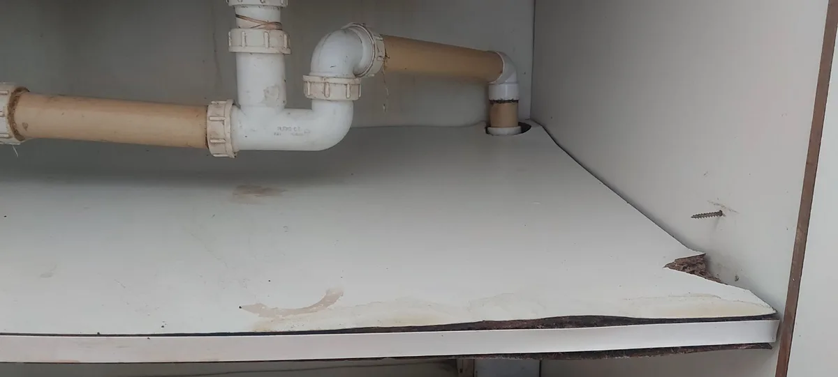 Why does water always splash onto your feet while doing dishes?