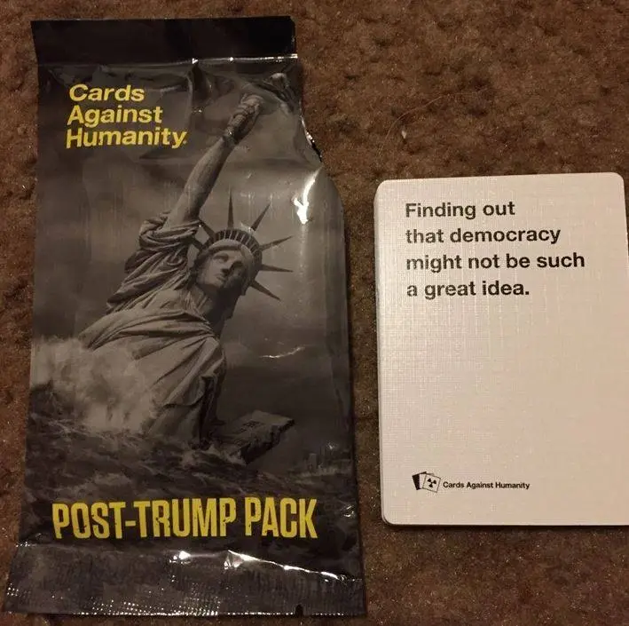 A 'Cards Against Humanity' game pack labeled 'POST-TRUMP PACK' featuring a black-and-white image of the Statue of Liberty…