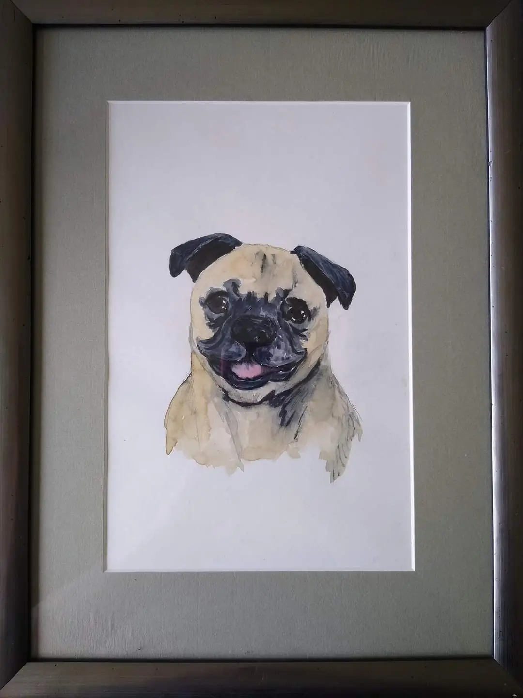 A watercolor painting of a pug dog's head and shoulders is displayed inside a simple dark frame with a light gray mat. The…