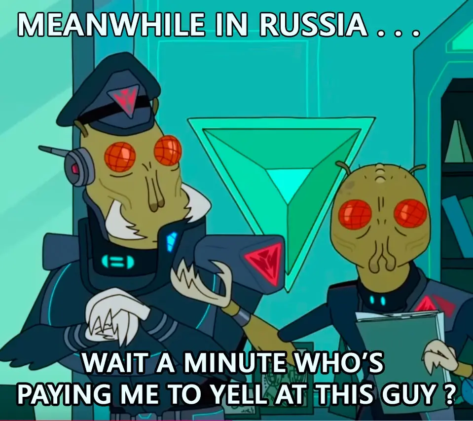 Two alien characters from the animated series 'Futurama' are shown in a futuristic setting. The character on the left…