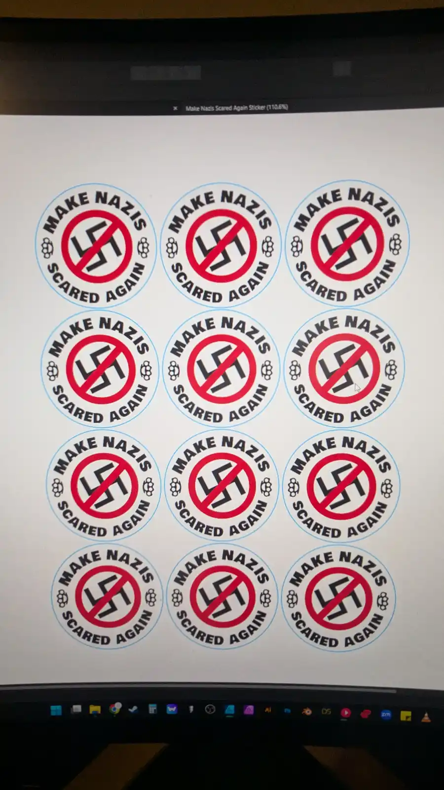 A computer screen displays a sheet of identical circular stickers. Each sticker features a red circle with a diagonal line…
