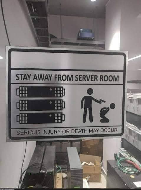 A sign in a server room warns 'STAY AWAY FROM SERVER ROOM' and 'SERIOUS INJURY OR DEATH MAY OCCUR', featuring icons of…