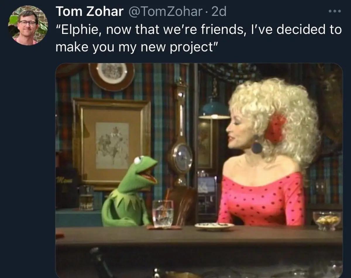 A still image from The Muppet Show shows Kermit the Frog sitting at a bar, looking up at a woman with blonde curly hair and…