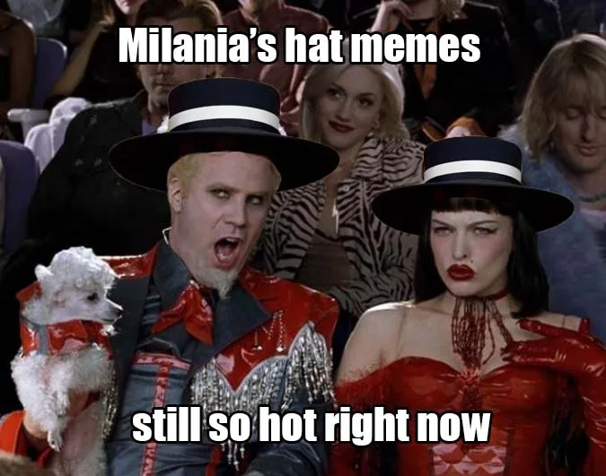 A still from the movie 'The Rocky Horror Picture Show' shows a man in a red outfit and black hat holding a small white dog…