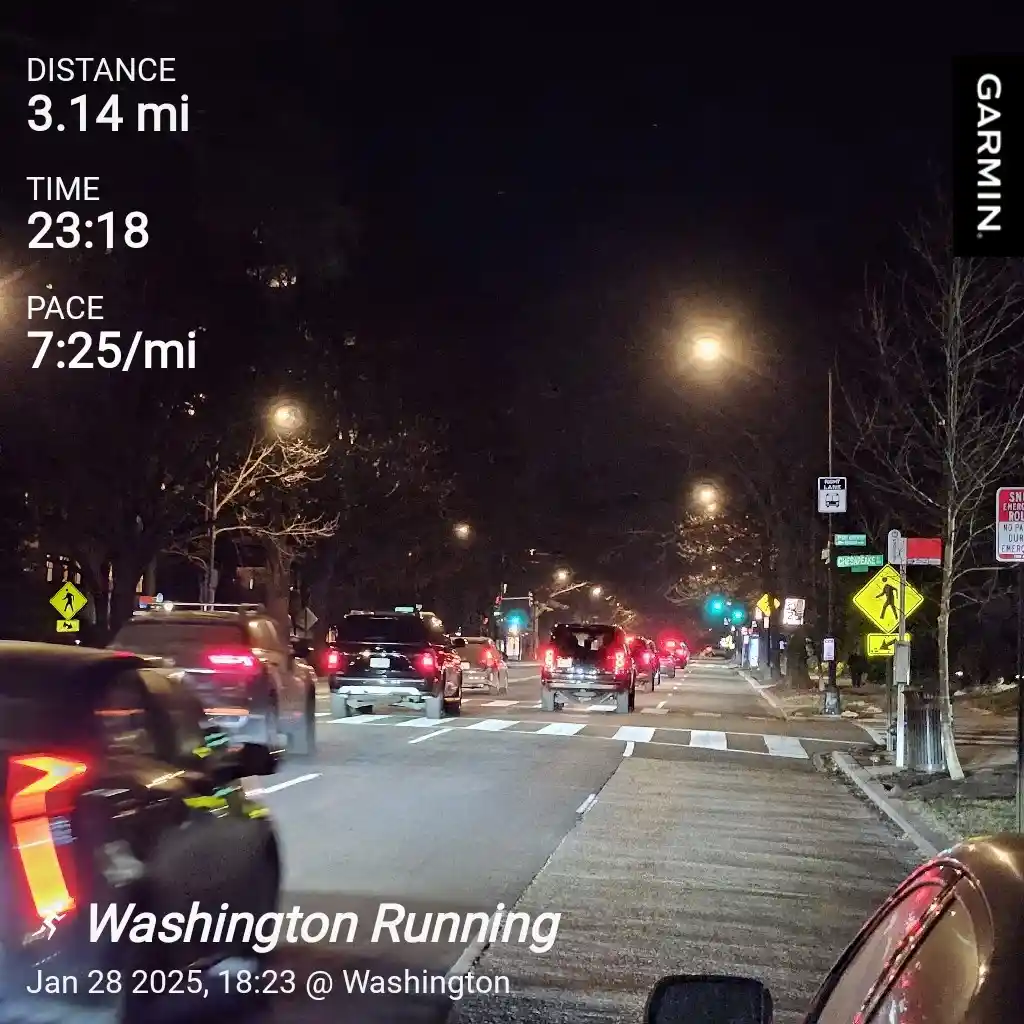 A nighttime street view from a Garmin device showing a running route with stats: distance 3.14 mi, time 23:18, pace 7:25/mi…